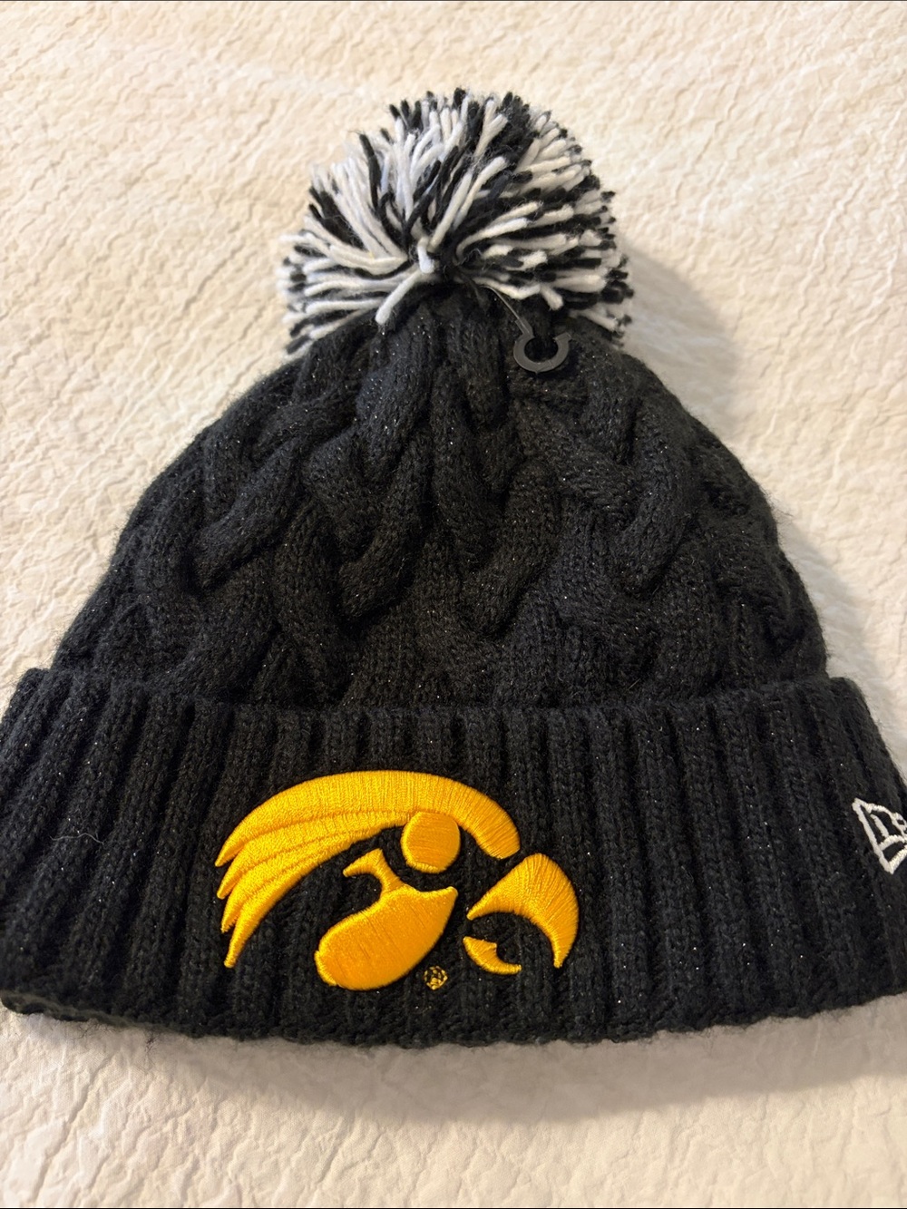 New Era Black Pom Knit Beanie with Yellow Hawkeye Logo